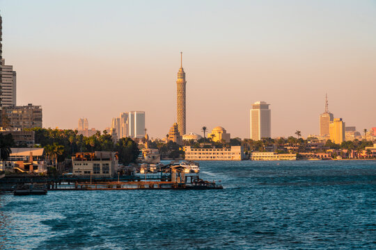 Egypt, Cairo, Pier in Gezira district at dusk with Cairo Tower and downtown skyline in background