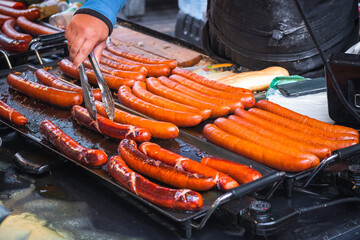 Grilled sausages bring prepared at Brick Lane market in London