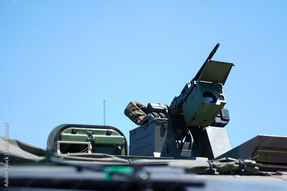 Wall mural military or army tank ready to attack and moving over a deserted battle field terrain.