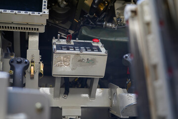 Military or army tank ready to attack and moving over a deserted battle field terrain.