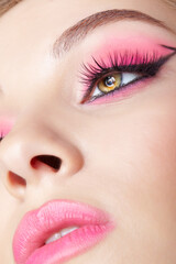 Closeup macro shot of human female face with pink makeup