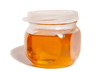 glass honey jar isolated on white background