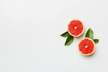 fresh Fruit grapefruit with Juicy grapefruit slices on colored background. Top view. Copy Space. creative summer concept. Half of citrus in minimal flat lay with copy space