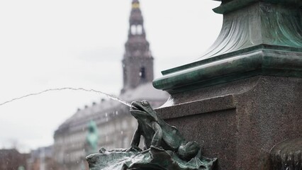 Stork fountain in Copenhagen Central square people walking in front of tower