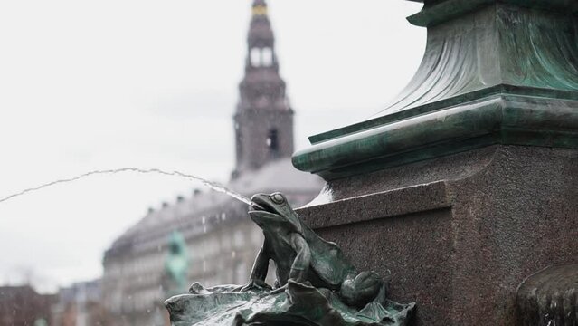 Stork fountain in Copenhagen Central square people walking in front of tower