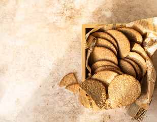 Delicious crackers with sesame and flax seeds on brown stone background. Healthy snack. Top view.