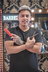 Young handsome man in barbershop having a haircut