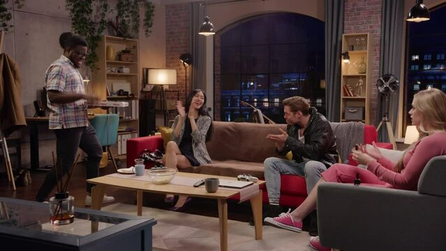 Television Sitcom. Four Diverse Friends having Fun in Living Room. Funny Sketch of One Couple Eating Pizza the Other Healthy Eating. TV Comedy Series Broadcasting on Network Channel,Streaming Service