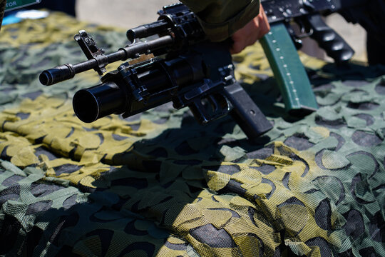 civilian trying a weapon at a military trade fair in May 2022, Bucharest, Romania. detail of the weapon held in the hand. photo during the day.