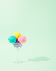 Creative concept made of colorful ice cream scoops on a pastel green background. Minimal summer concept. Copy space
