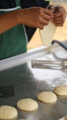 Street hawker preparing prata bread or roti canai for morning breakfast