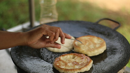 Street hawker preparing prata bread or roti canai for morning breakfast