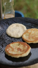 Street hawker preparing prata bread or roti canai for morning breakfast
