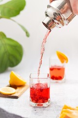 Summer homemade strawberry cocktail with orange splashing 