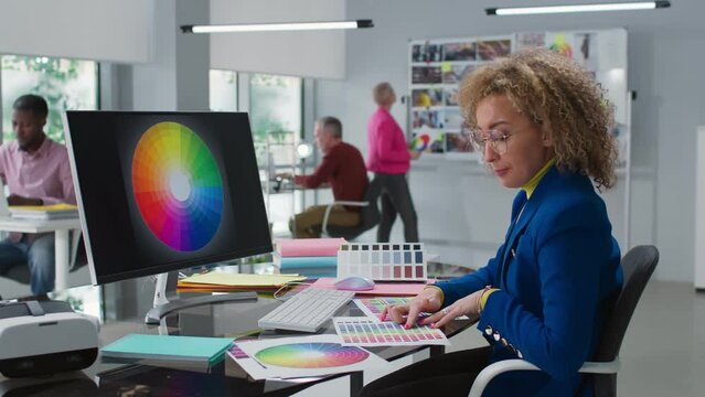 Woman designer study color spectrum and palette working in creative studio