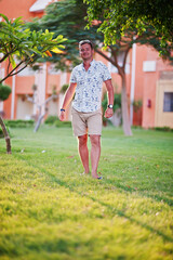 Fototapeta premium Young man at garden of egyptian resort.