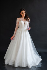 Fototapeta premium portrait of beautiful bride in wedding dress with fashion hairstyle and make-up