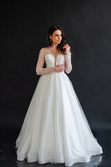 Beautiful bride in a magnificent white wedding dress of tulle with corset lacing and long beauty hair