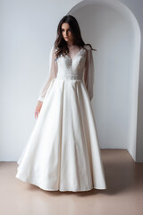 Fototapeta premium The beautiful woman posing in a wedding dress