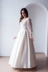 Fototapeta premium The beautiful woman posing in a wedding dress