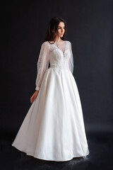 Fototapeta premium The beautiful woman posing in a wedding dress