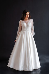 Fototapeta na wymiar The beautiful woman posing in a wedding dress