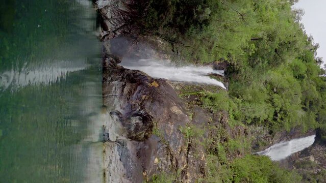 Vertical view of the Rio Blanco waterfall in Hornopiren National Park, Hualaihue, southern Chile. Crystal clear waters