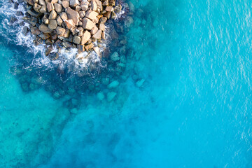 Aerial view of ocean wave reaching the jetty or breakwater at Fuvahmulah, a famous dive site in...