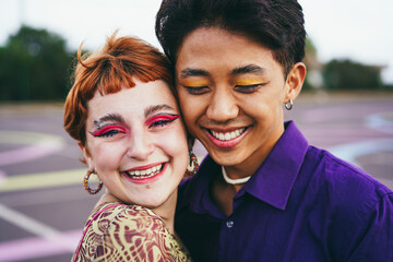Young diverse friends having fun outdoor - Focus on gay asian guy wearing make-up - obrazy, fototapety, plakaty
