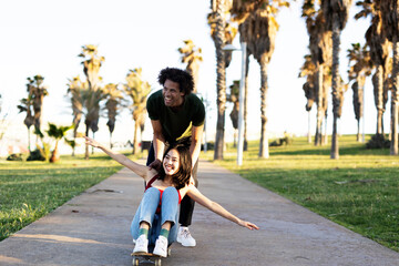 Obraz premium Beautiful couple having fun outdoors. Portrait of an excited young couple with skateboard