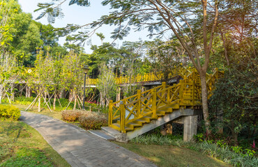 Fototapeta na wymiar Old wooden bridge with stairs in park