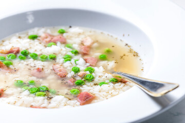 broth of smoked meat with green peas and rice