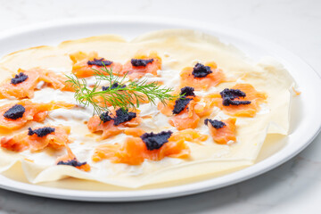 pancake with smoked salmon, black caviar and sour cream