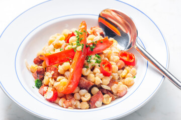 mixture of yellow peas and bacon served with red pepper and chilli