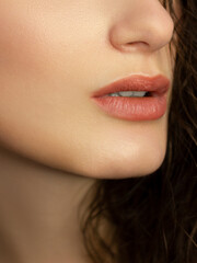 Fototapeta premium Perfect natural lip makeup. Close up macro photo with beautiful female mouth. Plump full lips. Close-up face detail. Perfect clean skin, light fresh lip make-up. Beautiful spa tender lip