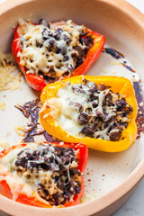 baked peppers filled with minced meat, rice, beans and cheese