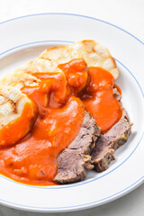 beef meat with tomato sauce with dumplings