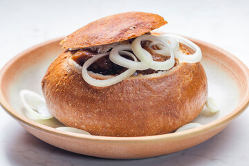 beef goulash in loaf of bread