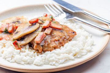 pork fillet with mushroom sauce and ham served with white rice