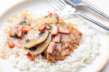 pork fillet with mushroom sauce and ham served with white rice