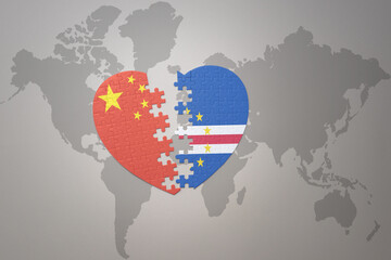 puzzle heart with the national flag of china and cape verde on a world map background. Concept.