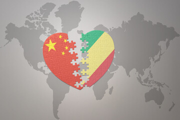 puzzle heart with the national flag of china and republic of the congo on a world map background. Concept.