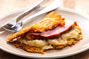 potato cakes with smoked meat and sour cabbage