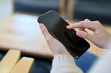 A woman hand tapping or touching on smartphone screen. Female using cellphone