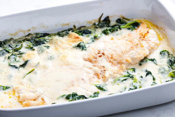 poultry meet baked with cheese and spinach leaves