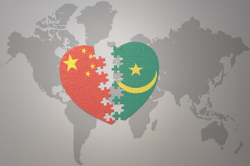 puzzle heart with the national flag of china and mauritania on a world map background. Concept.