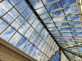 Skylight or glass sunroof ceiling of a building. Plastic ceiling with the Blue Sky. Modern design...
