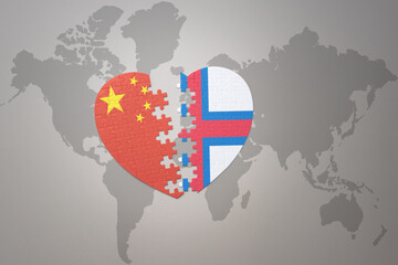 Fototapeta premium puzzle heart with the national flag of china and faroe islands on a world map background. Concept.