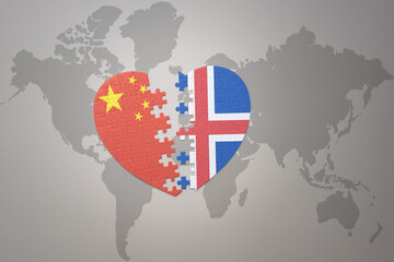puzzle heart with the national flag of china and iceland on a world map background. Concept.