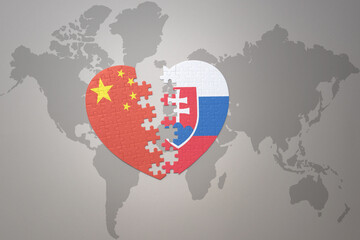 puzzle heart with the national flag of china and slovakia on a world map background. Concept.